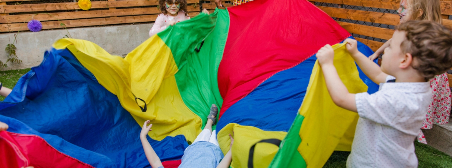 children playing with toy parachute